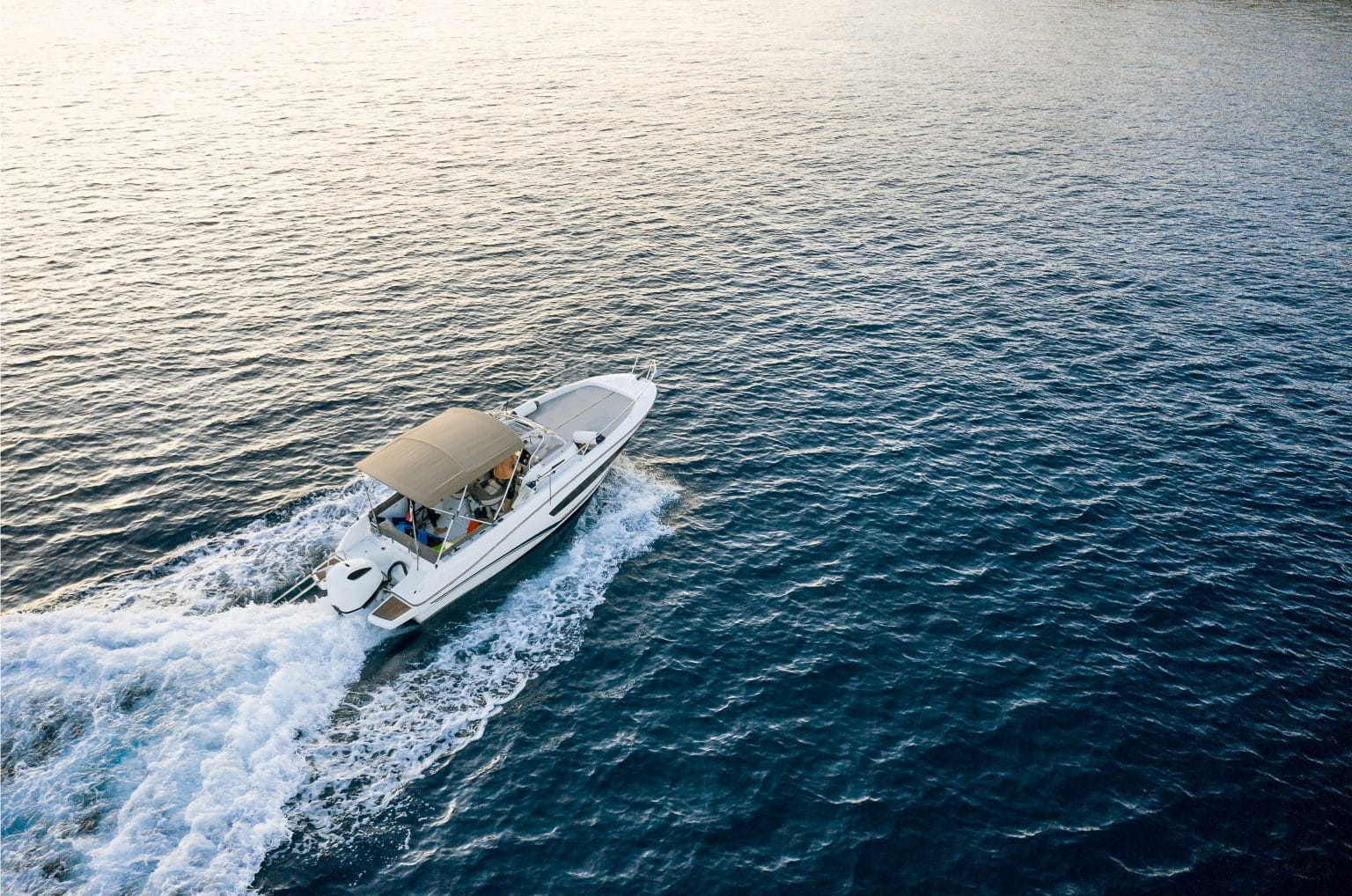 Family relaxing on a boat on the water with peace of mind from Progressive boat insurance coverage